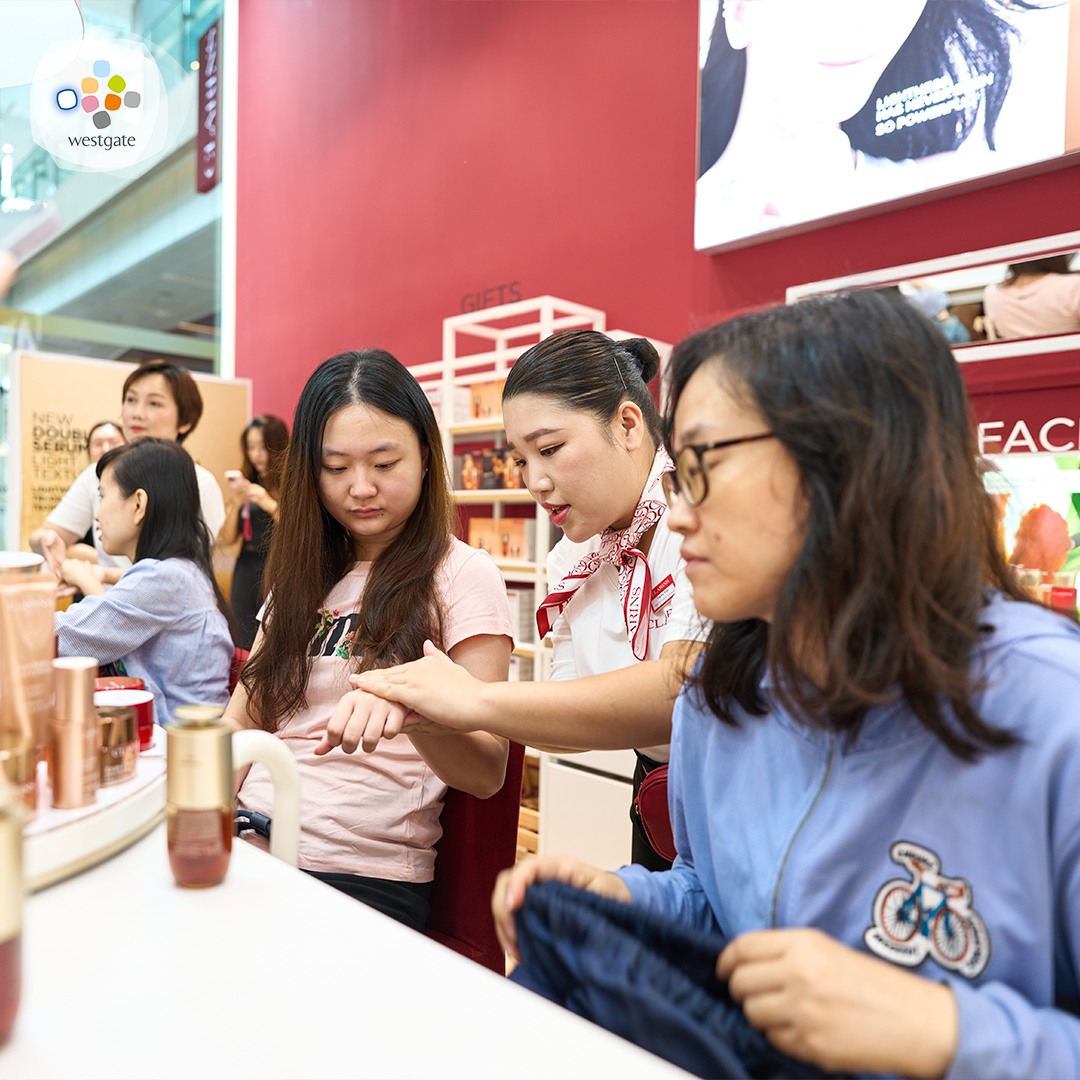 Attendees exploring Clarins products at the beauty workshop