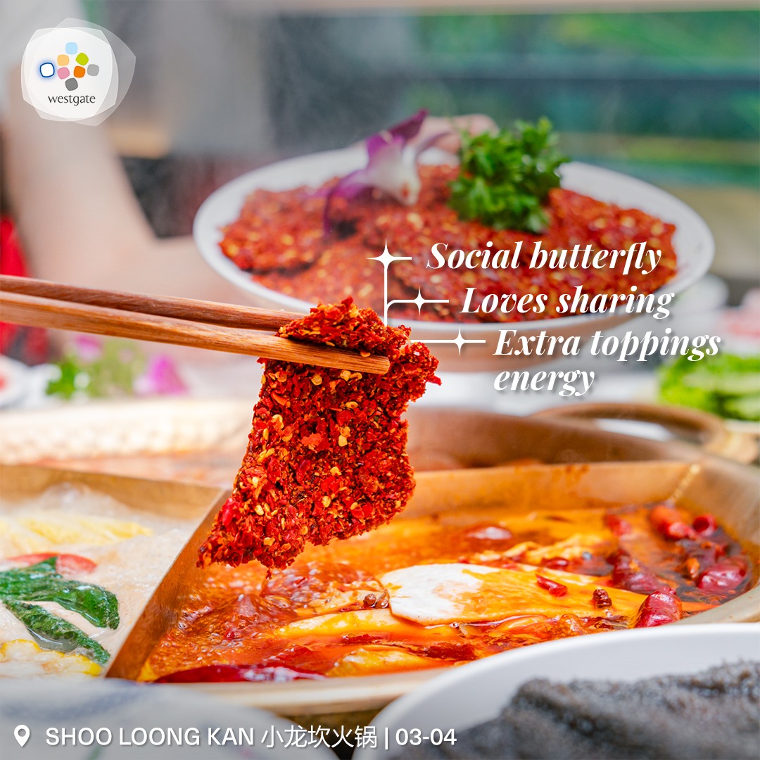 A steaming pot of spicy mala hot pot with vibrant red broth