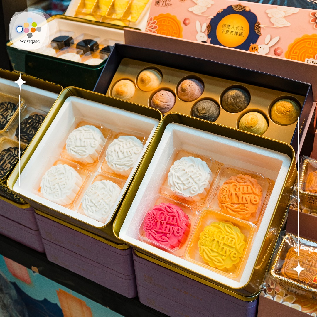 Visitors exploring various vendor stalls offering a wide selection of mooncakes.