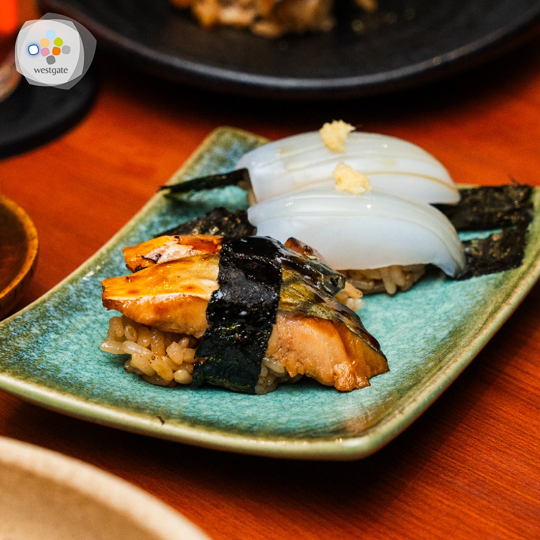 Chef preparing sushi with precision at Sushi Zushi's grand opening